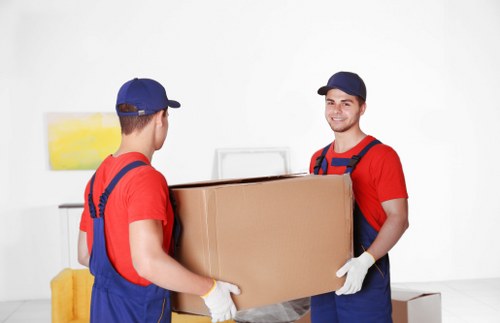 Collection of furniture and boxes being separated for recycling at a local removal job