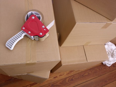 Moving van loading boxes and furniture on a West London residential street