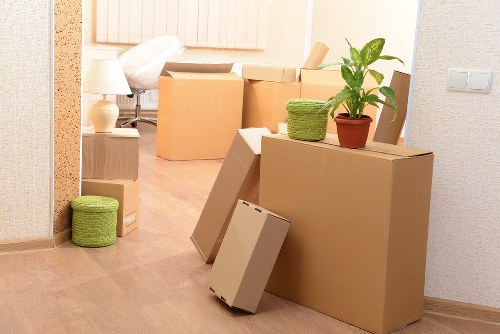Specialist movers handling a grand piano in a Hammersmith property